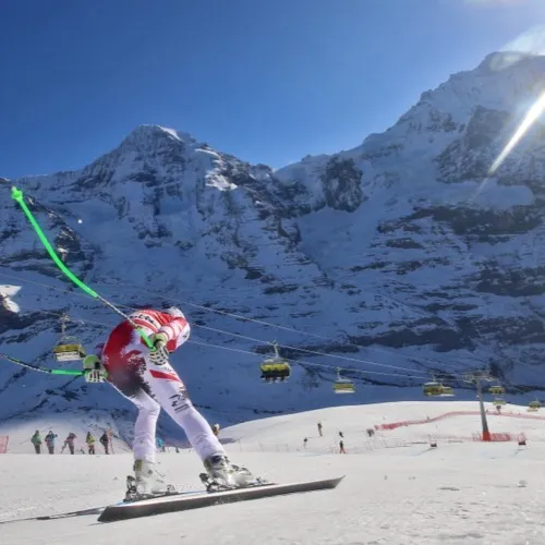 Hannes Reichelt racing downhill against snowy mountains