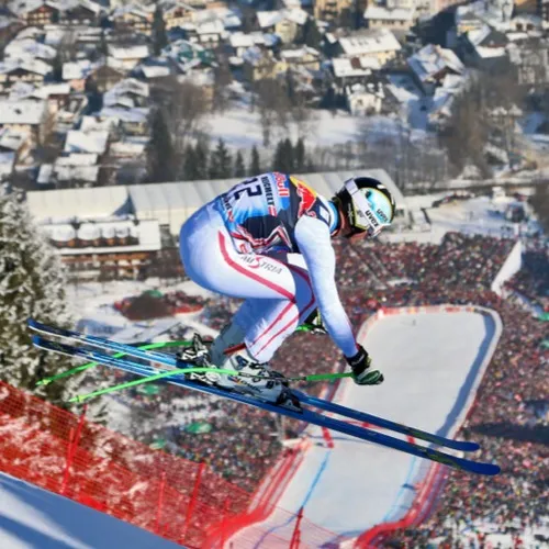 Hannes Reichelt jumping over the Hausbergkante in Kitzbühel, in front of the finish stadium